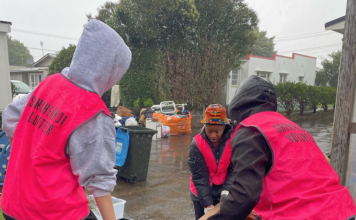 Volunteers help residents in Auckland's Mt Roskill to clear up after the flash floods hit the city last weekend