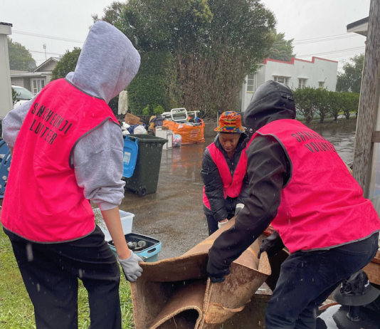 Volunteers help residents in Auckland's Mt Roskill to clear up after the flash floods hit the city last weekend