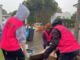 Volunteers help residents in Auckland's Mt Roskill to clear up after the flash floods hit the city last weekend