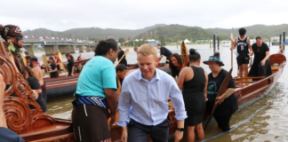 Prime Minister Chris Hipkins, who was wearing formal attire after meeting with Iwi chairs, rolled up his suit pants to join rangatahi who were waka training at Waitangi on 3 February 2023