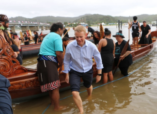 Prime Minister Chris Hipkins, who was wearing formal attire after meeting with Iwi chairs, rolled up his suit pants to join rangatahi who were waka training at Waitangi on 3 February 2023
