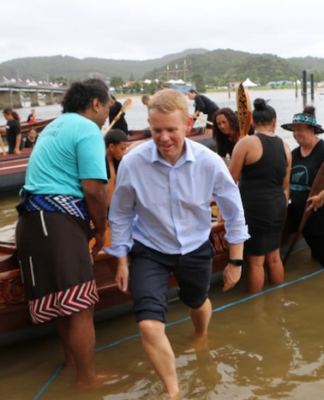 Prime Minister Chris Hipkins, who was wearing formal attire after meeting with Iwi chairs, rolled up his suit pants to join rangatahi who were waka training at Waitangi on 3 February 2023