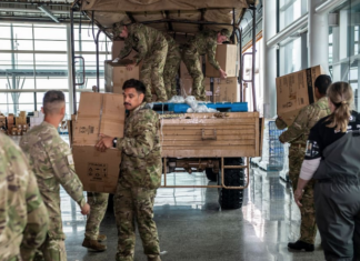 NZ Defence Force soldiers distributing food and supplies