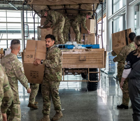 NZ Defence Force soldiers distributing food and supplies