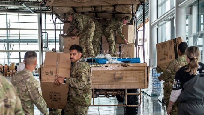 NZ Defence Force soldiers distributing food and supplies