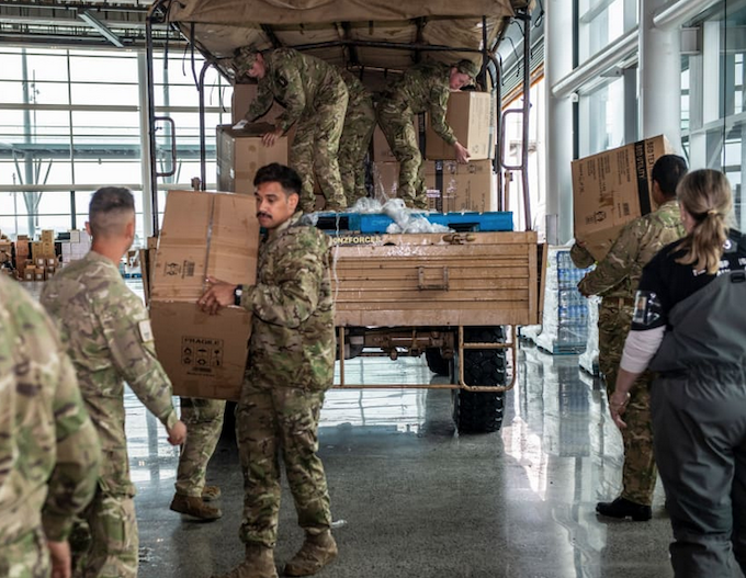 NZ Defence Force soldiers distributing food and supplies