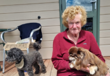 Bay View cyclone survivor Maureen Dorr holds her dog Pancho