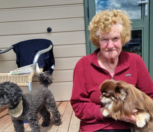 Bay View cyclone survivor Maureen Dorr holds her dog Pancho