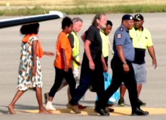 Police Commissioner David Manning (right) escorts the the three last hostages to be released by the gunmen