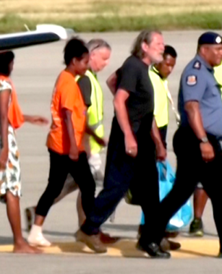 Nightmare over for final 3 PNG freed hostages – police hunt their captors Police Commissioner David Manning (right) escorts the the three last hostages to be released by the gunmen