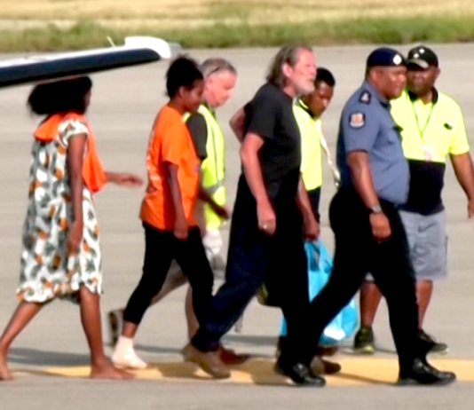 Police Commissioner David Manning (right) escorts the the three last hostages to be released by the gunmen