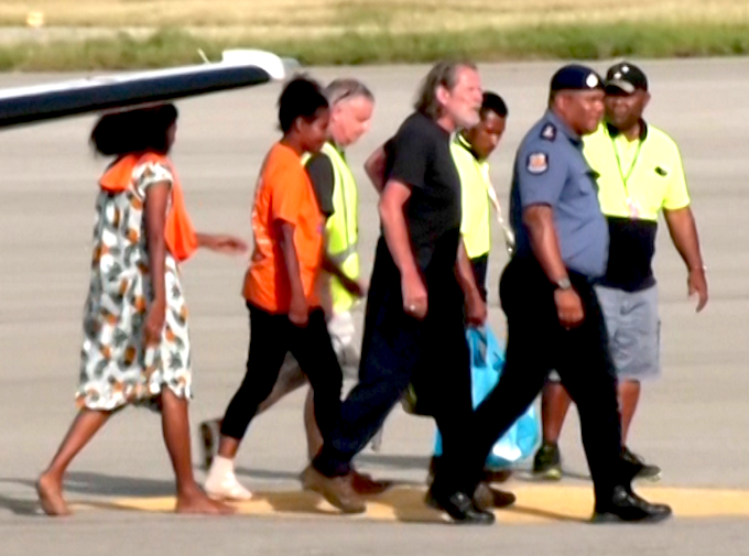 Police Commissioner David Manning (right) escorts the the three last hostages to be released by the gunmen