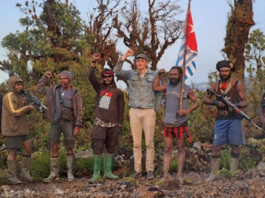 Hostage NZ pilot Philip Mehrtens pictured with his armed West Papuan rebel captors