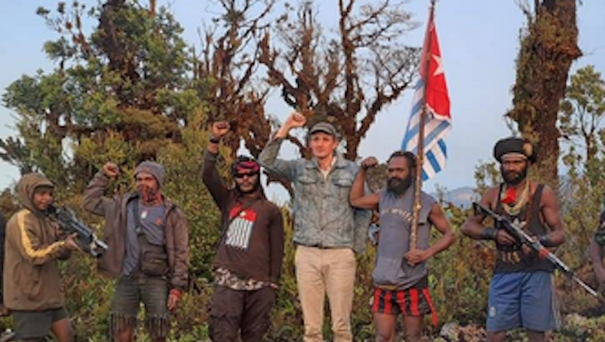 Hostage NZ pilot Philip Mehrtens pictured with his armed West Papuan rebel captors