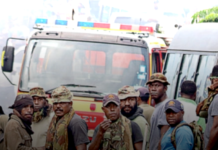 PNG Defence Force soldiers keep watch after running riot in the Port Moresby suburb of Boroko