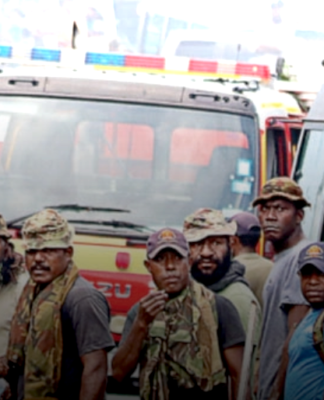 PNG Defence Force soldiers keep watch after running riot in the Port Moresby suburb of Boroko