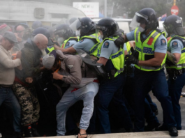 Police and protestors clash at the conclusion of the 2022 occupation at NZ's Parliament grounds
