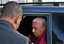 Former Fiji prime minister Voreqe Bainimarama arrives at the Police CID headquarters in Suva last night before being charged and held at Totogo Police Station