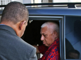 Former Fiji prime minister Voreqe Bainimarama arrives at the Police CID headquarters in Suva last night before being charged and held at Totogo Police Station
