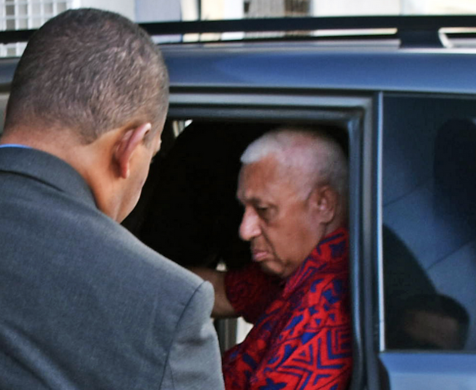 Former Fiji prime minister Voreqe Bainimarama arrives at the Police CID headquarters in Suva last night before being charged and held at Totogo Police Station