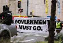 An anti-government protester in Wellington marching towards Parliament