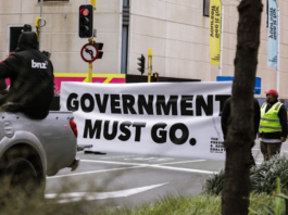 An anti-government protester in Wellington marching towards Parliament