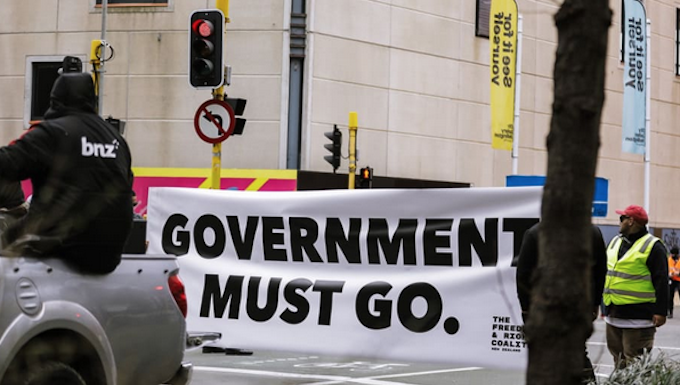 An anti-government protester in Wellington marching towards Parliament