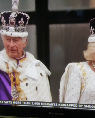 King Charles III and Queen Camilla wave from the balcony at Buckingham Palace