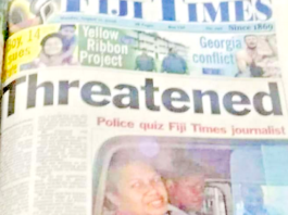 Fiji Times journalist Serafina Silaitoga with a police officer