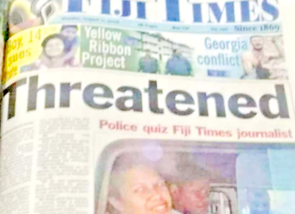 Fiji Times journalist Serafina Silaitoga with a police officer