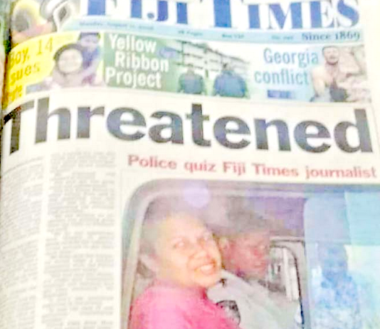 Fiji Times journalist Serafina Silaitoga with a police officer