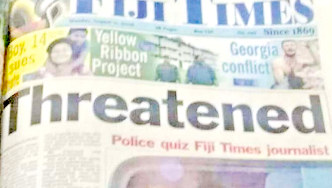 Fiji Times journalist Serafina Silaitoga with a police officer