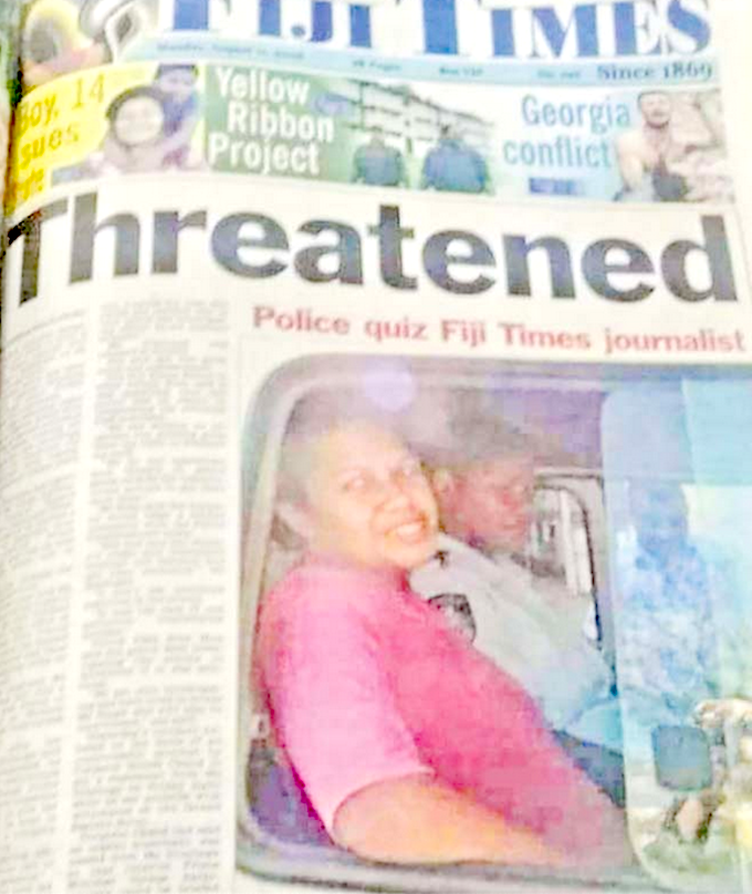 Fiji Times journalist Serafina Silaitoga with a police officer
