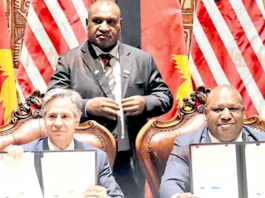 US Secretary of State Antony Blinken (from left), PNG Prime Minister James Marape (standing) and Defence Minister Win Daki after signing the US-PNG defence cooperation pact in Port Moresby