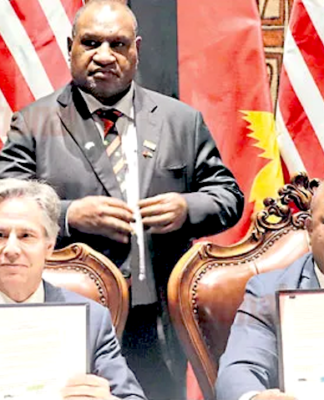 US Secretary of State Antony Blinken (from left), PNG Prime Minister James Marape (standing) and Defence Minister Win Daki after signing the US-PNG defence cooperation pact in Port Moresby