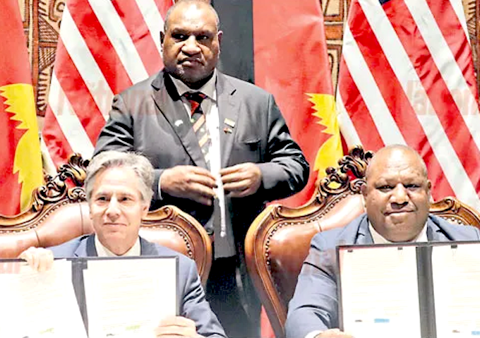 US Secretary of State Antony Blinken (from left), PNG Prime Minister James Marape (standing) and Defence Minister Win Daki after signing the US-PNG defence cooperation pact in Port Moresby