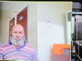 Papua Governor, Lukas Enembe on a video monitor