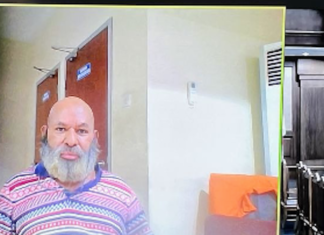 Papua Governor, Lukas Enembe on a video monitor