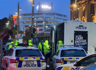 Police officers in high-vis vests have today re-entered the high-rise Auckland central building