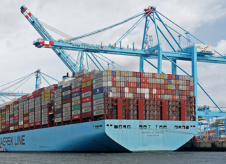 Huge container ships carrying import and export marine cargo loads