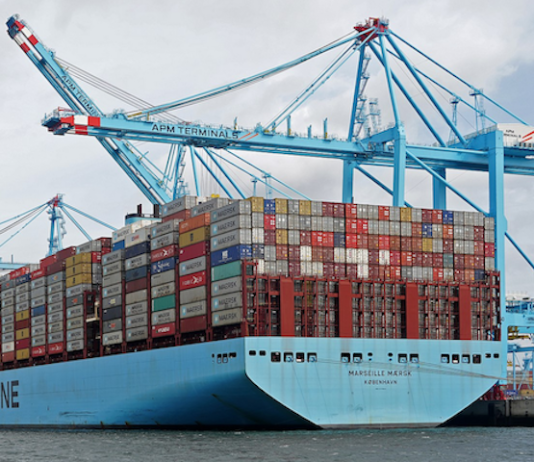 Huge container ships carrying import and export marine cargo loads