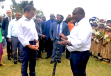 Prime Minister James Marape presenting a traditional eagle wood spear with totems to French President Emmanuel Macron