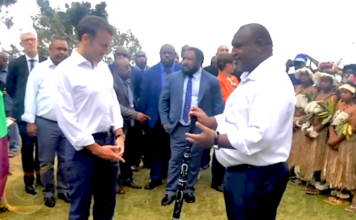 Macron warns of ‘new colonialism’ in Pacific, but clings to French ‘colonies’ Prime Minister James Marape presenting a traditional eagle wood spear with totems to French President Emmanuel Macron
