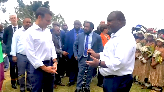 Macron keen on Varirata forest lookout for bilateral talks with PNG Prime Minister James Marape presenting a traditional eagle wood spear with totems to French President Emmanuel Macron