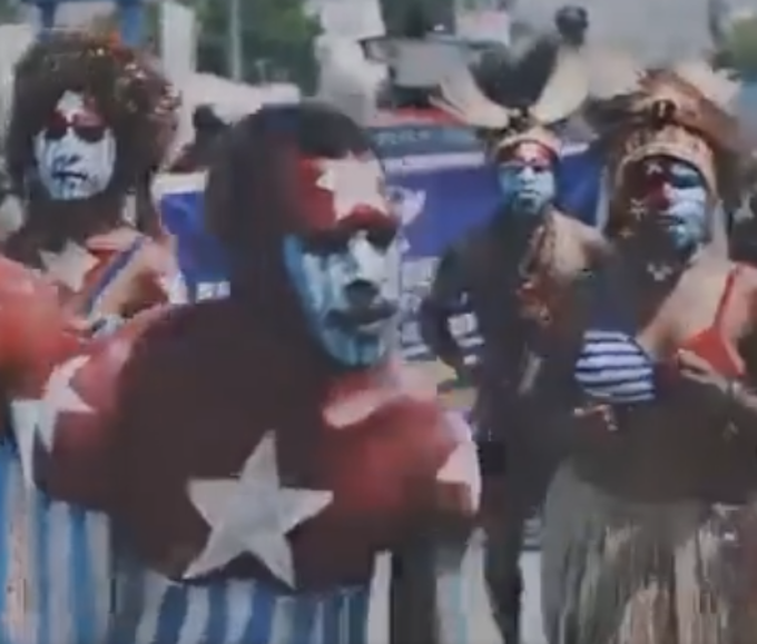 A screenshot of a video of a MACFEST2023 and Melanesian Spearhead Group solidarity display showing Papuans daubed in their Morning Star flag colours