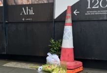 Orchids left at the Auckland construction site in memory of the two dead victims