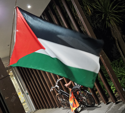 A Palestinian flag at the Auckland venue for author Antony Loewenstein's address about his new book The Palestine Laboratory