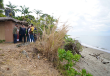 French President Emmanuel Macron visits Kanak villagers yesterday in an area near Tuoho