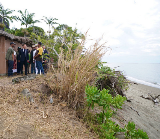French President Emmanuel Macron visits Kanak villagers yesterday in an area near Tuoho
