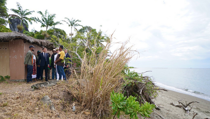 French President Emmanuel Macron visits Kanak villagers yesterday in an area near Tuoho